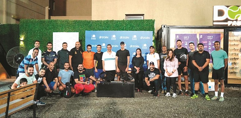 بدر الخرافي يتوسط موظفي زين في بطولة الپادل