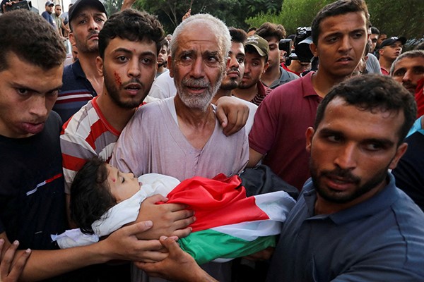 فلسطينيون يشيعيون طفلة قتلت في الغارات الاسرائيلية على غزة ( رويترز)