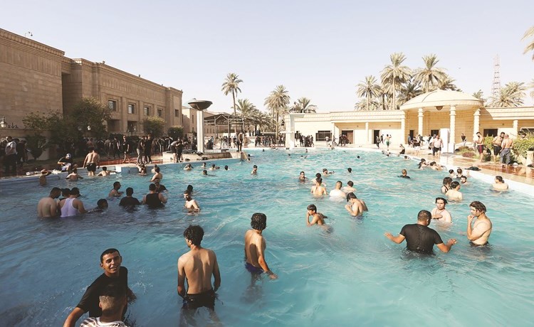 أنصار التيار الصدري يسبحون في مسبح القصر الجمهوري	(رويترز)