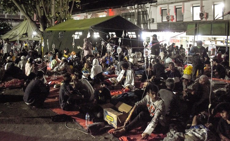 مصابون يتلقون العلاج في ساحة أحد مستشفيات منطقة سيانجور نتيجة الزلزال أمس 	(رويترز)