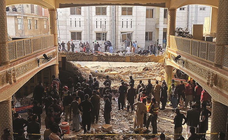 مسؤولون أمنيون يتفقدون موقع انفجار بمسجد داخل مقر الشرطة في بيشاور	(أ.ف.پ)