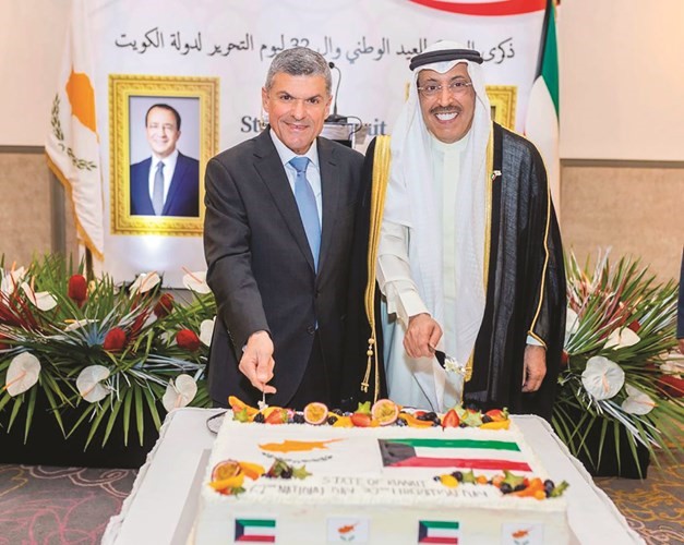 السفير عبدالله الخرافي خلال قطع كعكة الاحتفال بمشاركة ممثل الحكومة القبرصية الوزير جورج باباناستاسيو