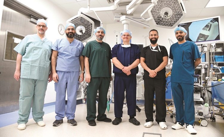 د.سليمان المزيدي والجراح العالمي تيم تولينز مع فريق عمل المستشفى