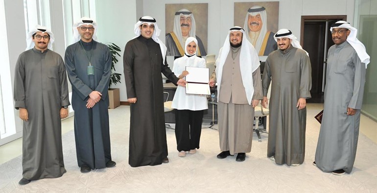 د.فايز الظفيري ود.جاسم الحمدان خلال تكريم إحدى الفائزات