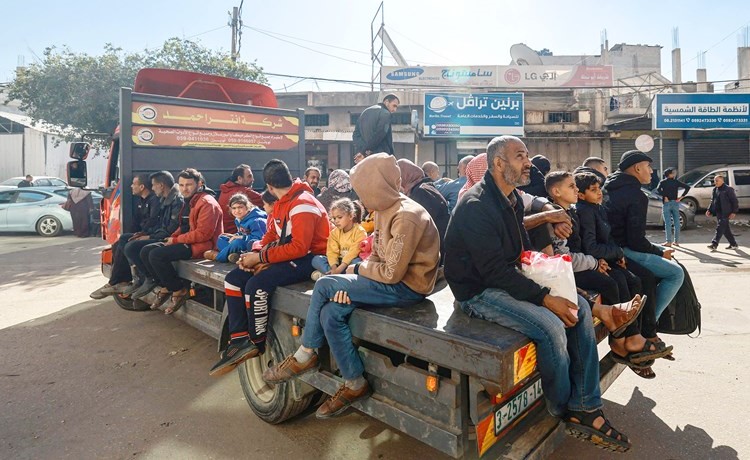 فلسطينيون يركبون شاحنة صغيرة كوسيلة نقل في رفح بجنوب قطاع غزة 	(أ.ف.پ)