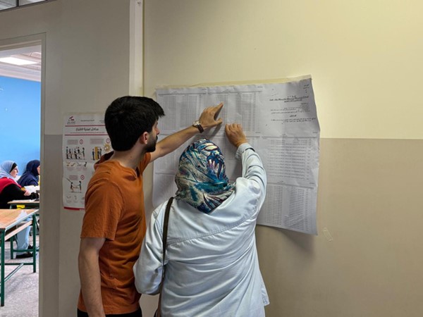 صورة أرشيفية لناخبين يبحثان عن اسميهما في قوائم الانتخابات البلدية والاختيارية الأخيرة في بيروت (محمود الطويل)