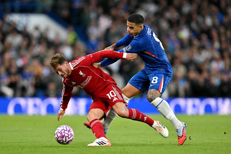 لاعب ليڤربول ماك أليستر يحاول الاستحواذ على الكرة قبل مواطنه الأرجنتيني انزو فيرنانديز