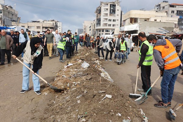 متطوعون في حملة «حنعمرها تاني» ينظفون احد شوارع مدينة غزة (ا.ف.پ)