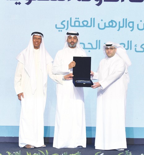 وزير الدولة لشؤون البلدية ووزير الدولة لشؤون الإسكان م.عبد اللطيف المشاري يسلم خالد الشملان درعا تكريمية بحضور م.بدر السلمان