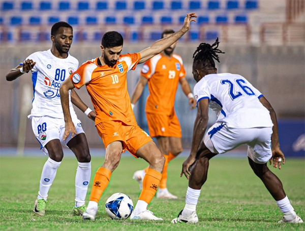 مهاجم البرتقالي شبيب الخالدي يحاول المرور من لاعبي الجهراء عبدالله الداحس وجونيور بوريس